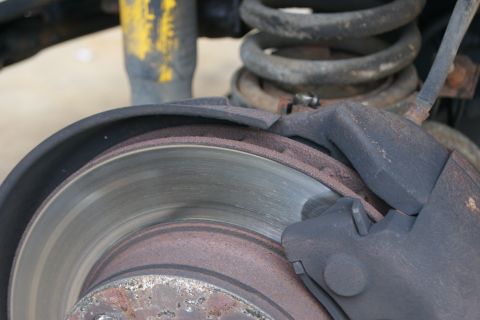 1978 Ford Bronco - The brake system shows signs of wear and tear, with rust visible on the rotor and caliper components.