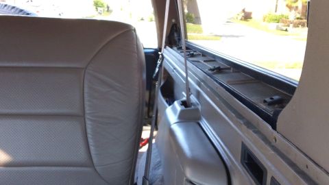 1994 Ford Bronco - Interior view of a 1994 Ford Bronco, showing the rear passenger seat and window frame.