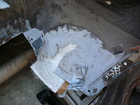 1976 Chevrolet Corvette - Fiberglass patch and repair work on a vehicle's frame, showing exposed wiring and tape.