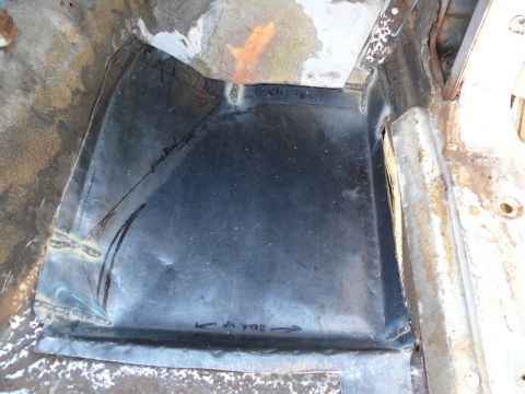 1976 Chevrolet Corvette - A section of a car's floor pan shows repair work with scribe lines and directional arrows indicating a bend.