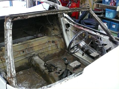 1976 Chevrolet Corvette - Interior of a 1976 Chevrolet Corvette undergoing restoration, with most components removed.