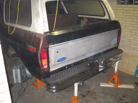 1979 Ford Bronco - Rear view of a 1978 Ford Bronco undergoing repairs, elevated on jack stands.