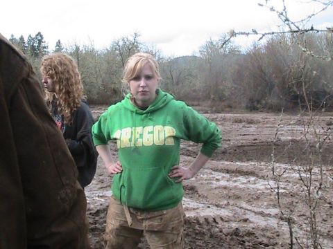 1978 Ford Bronco - A woman in an "Oregon" hoodie and muddy pants poses in a muddy outdoor scene.