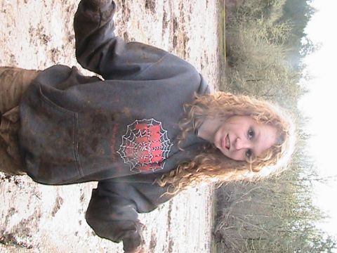 1978 Ford Bronco - A person covered in mud poses for a photo, with a spiderweb graphic on their sweatshirt.