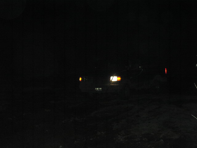 Truck with headlights on at night, front view