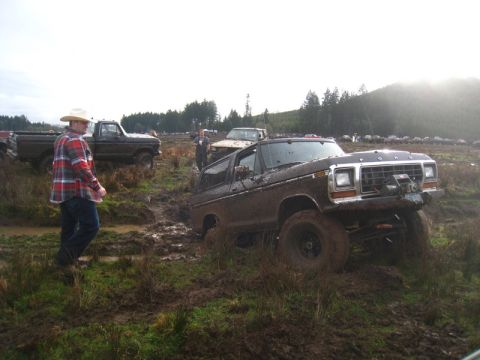 1978 Ford Bronco - Several trucks are stuck in the mud during an off-road event.
