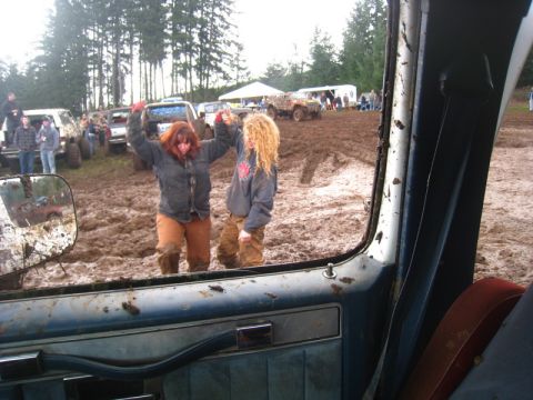 1978 Ford Bronco - A muddy scene unfolds at a mud bogging event, with participants and vehicles navigating the challenging terrain.