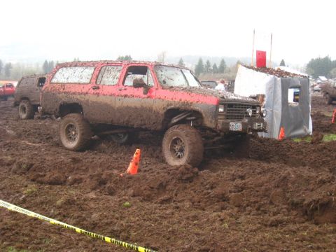 1978 Ford Bronco - This red SUV is deep in the mud during an off-road event.