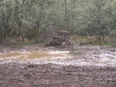 1978 Ford Bronco - Off-road buggy navigating a challenging muddy terrain.