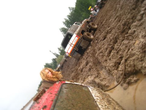 1978 Ford Bronco - Multiple off-road vehicles are stuck in a muddy terrain during an event.