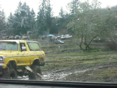 1978 Ford Bronco - 1978 Ford Bronco navigating a muddy off-road course with other vehicles present.