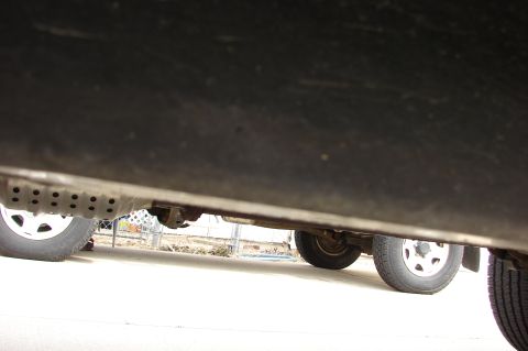 2004 Toyota Tacoma - The underside of a 2004 Toyota Tacoma reveals its exhaust system and rear wheel assembly.