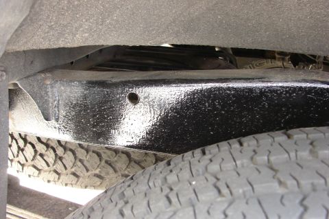 2004 Toyota Tacoma - Close-up view of the chassis and tire of a 2004 Toyota Tacoma.
