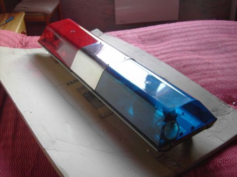 1991 Ford Crown Victoria - This light bar features red and blue lenses and is mounted on a piece of cardboard.