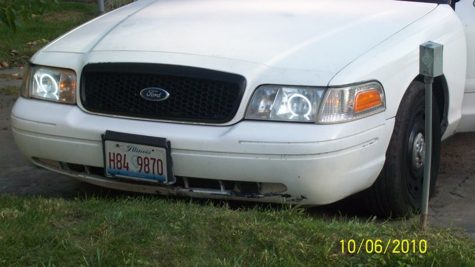 White Ford Crown Victoria front end with halo projector headlights, Illinois plate
