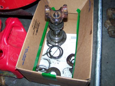 1992 Ford Bronco - A box contains a driveshaft U-joint, bearings, and seals, with a red gas can visible to the side.