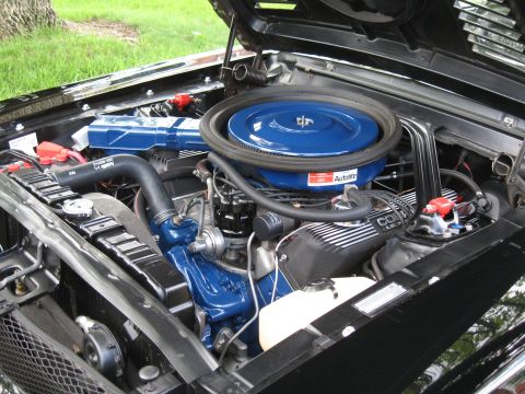 1968 Shelby GT500 - The engine bay of a black 1968 Shelby GT500 features a prominent blue air cleaner and Cobra Le Mans valve covers.