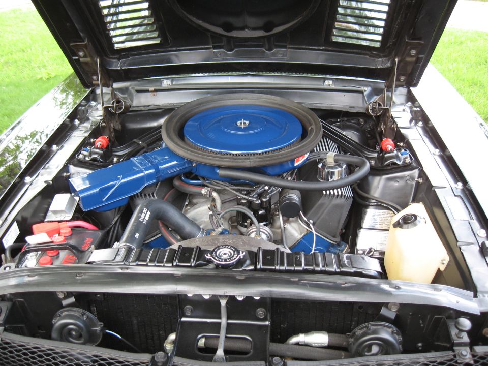 Black 1968 Shelby GT500 engine bay with blue air cleaner and intake manifold