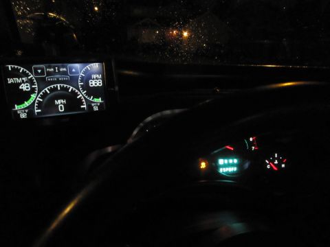 2008 Jeep Wrangler - Digital dashboard and instrument cluster display information at night.