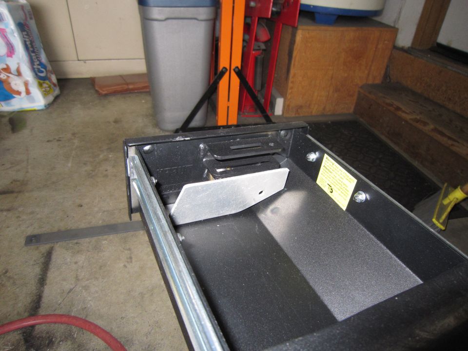 metal drawer slide mechanism with yellow warning sticker