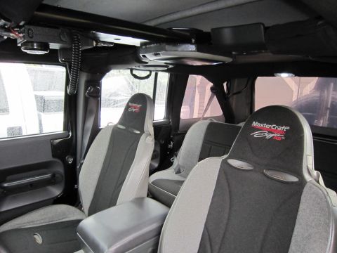 2008 Jeep Wrangler - The interior of a Jeep Wrangler features custom MasterCraft seats and a CB radio mounted overhead.