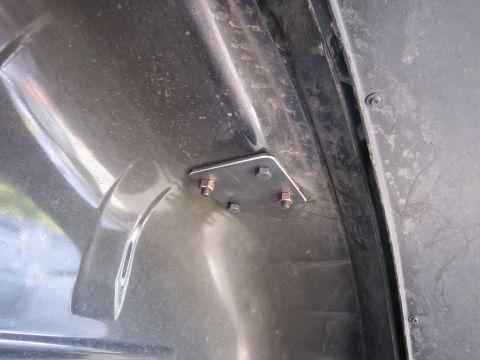 2008 Jeep Wrangler - Metal bracket attached with bolts to a black plastic interior panel.