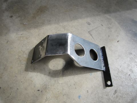 2008 Jeep Wrangler - A custom metal bracket with two circular openings is shown resting on a concrete surface.