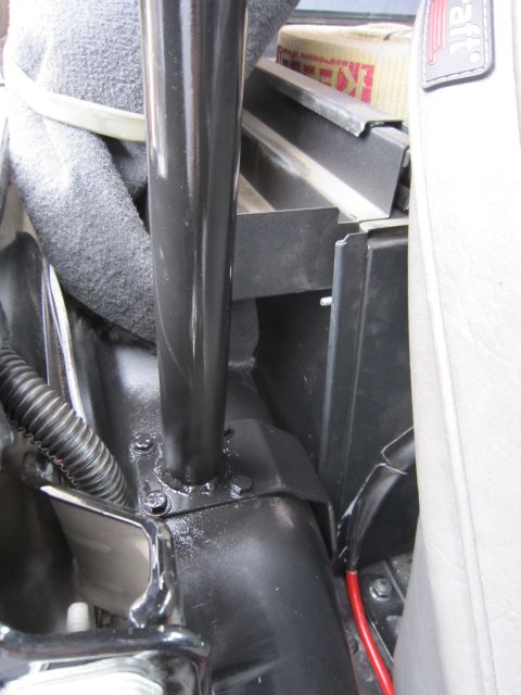 2008 Jeep Wrangler - Detail of a roll cage mounting point inside a vehicle, showing structural components and wiring.