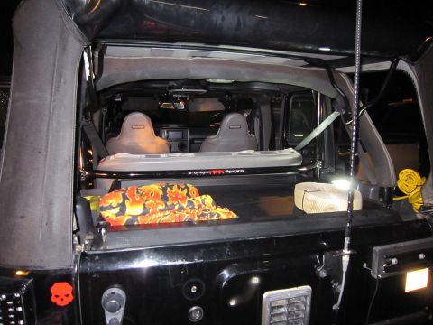 2008 Jeep Wrangler - The interior of a black Jeep Wrangler is visible, two bucket seats and a roll bar. The registry claim of 2008 is not supported by visible e…