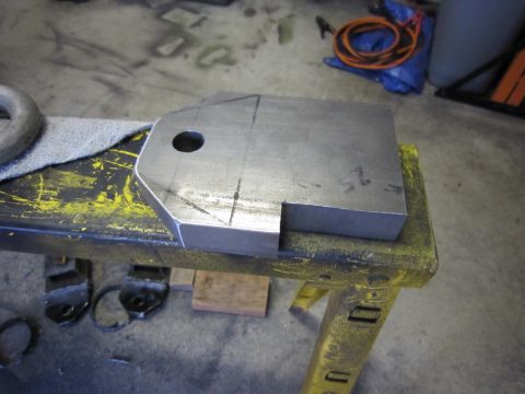 2008 Jeep Wrangler - Fabricated metal part with scribe lines and a hole, resting on a yellow workbench.