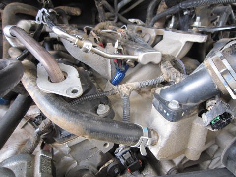 2008 Jeep Wrangler - Engine bay detail showing various hoses, connectors, and wiring harnesses.