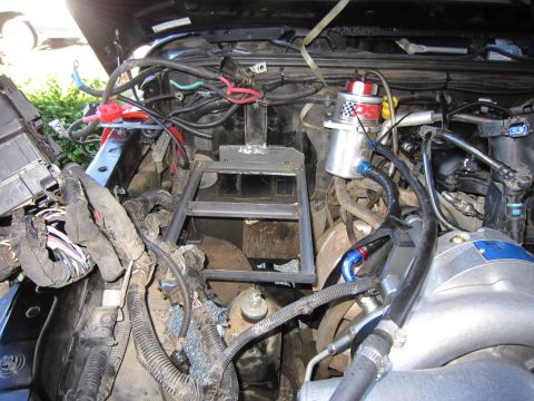 2008 Jeep Wrangler - Custom dual battery mount installed in the engine bay, showing complex wiring and plumbing.