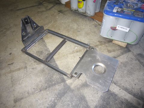 2008 Jeep Wrangler - A metal bracket and two batteries are visible on a concrete floor.