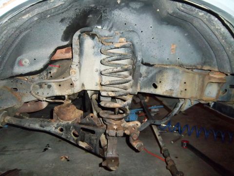 1989 Ford F-150 - Close-up view of the front suspension system, showing the coil spring and control arm.