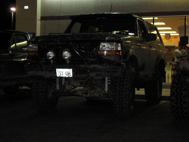 Black Ford Bronco, front view, with off-road tires and lights. License plate 154-GBE