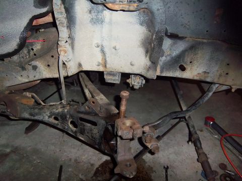 1989 Ford F-150 - Undercarriage view of disassembled truck suspension parts, showing wear and rust.