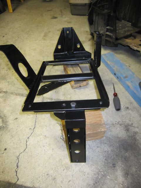 2008 Jeep Wrangler - A black metal bracket, possibly for a dual battery system, is shown on a concrete floor.