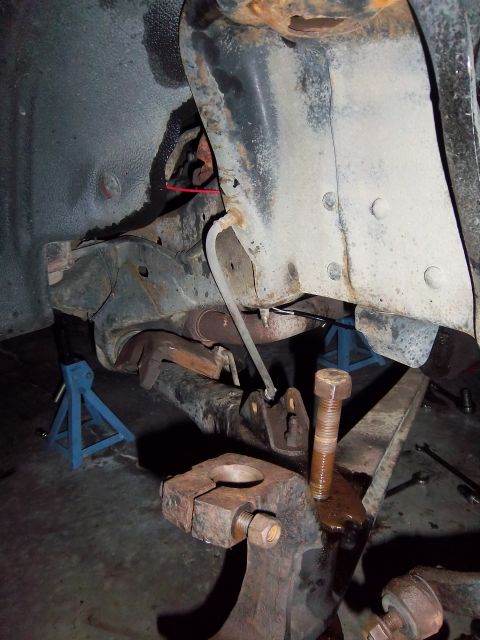 1989 Ford F-150 - Close-up view of heavily rusted truck suspension components and frame elements.