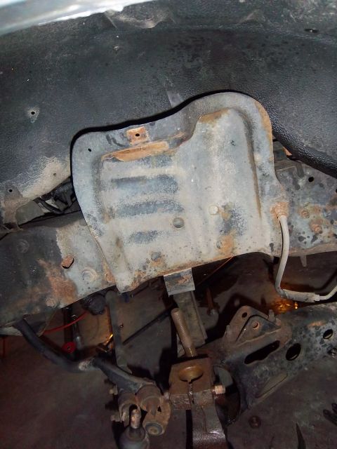 1989 Ford F-150 - This image shows a close-up of a vehicle's suspension system, highlighting a rusted metal component.