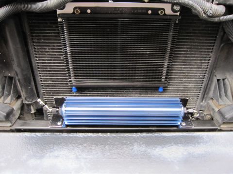 2008 Jeep Wrangler - An aftermarket blue transmission cooler is installed in front of the vehicle's main radiator.