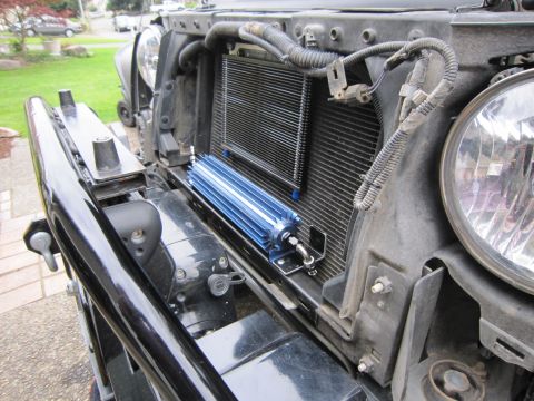 2008 Jeep Wrangler - Front view of a black Jeep Wrangler showing the grille and an aftermarket blue oil cooler.