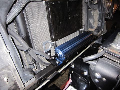 2008 Jeep Wrangler - Aftermarket blue oil cooler installed in front of the vehicle's radiator.