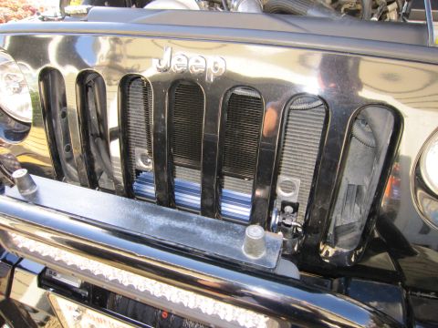 2008 Jeep Wrangler - Close-up of a Jeep Wrangler's front grille, showing the iconic seven-slot design and a row of LED lights.