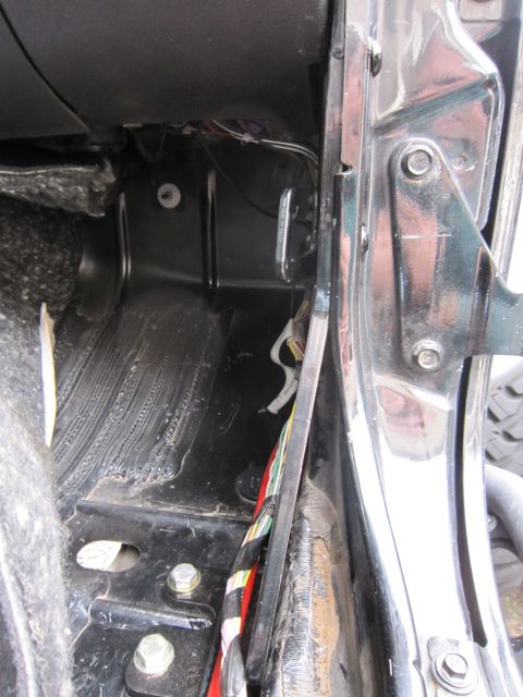 2008 Jeep Wrangler - Close-up view of the interior floor and door jamb area, showing wiring and structural elements.