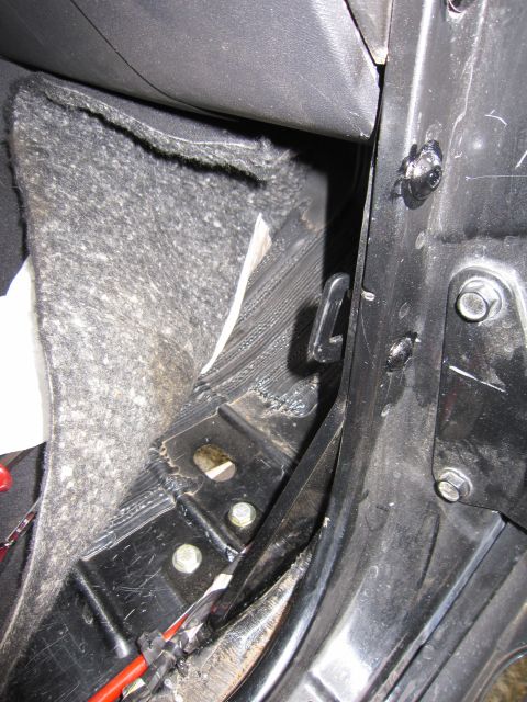 2008 Jeep Wrangler - Interior view of a car's door latch mechanism and carpeted area.