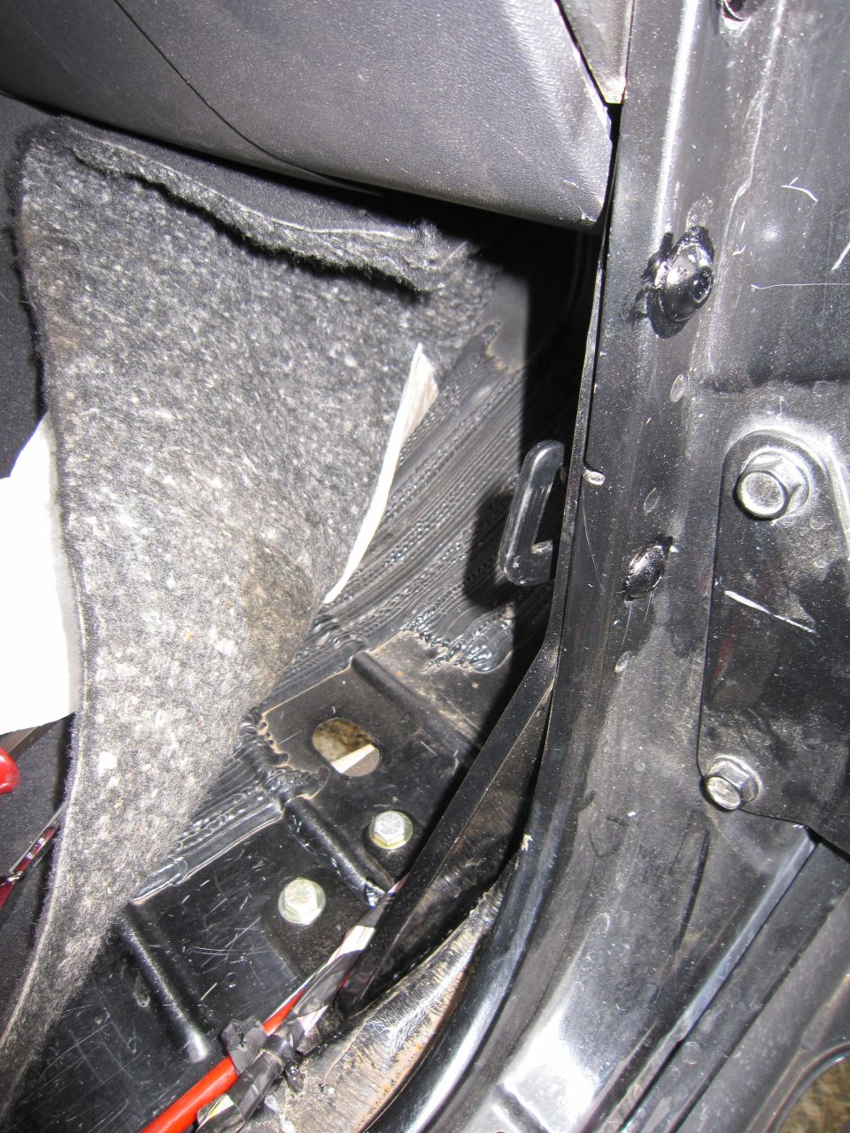 Close-up of a vehicle's interior door latch mechanism and surrounding trim