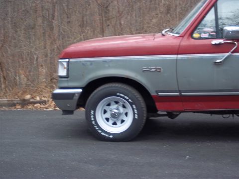 1989 Ford F-150 - This two-tone Ford F-150 shows its front quarter panel and wheel.