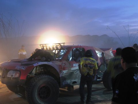 1986 Ford Bronco - A custom off-road truck is prepared for an event, with people gathered around.