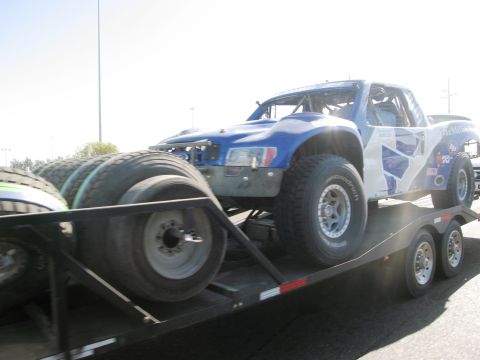 1986 Ford Bronco - A custom off-road truck is transported on a trailer, ready for its next race.