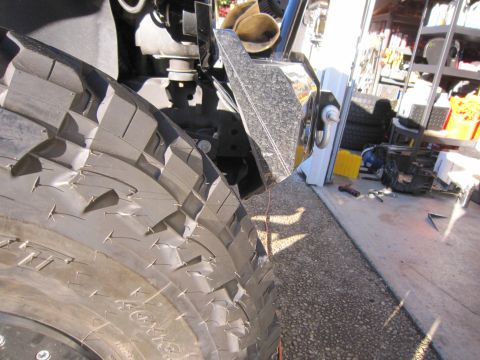 2008 Jeep Wrangler - Detail of an off-road tire and bumper assembly, likely from a Jeep Wrangler.
